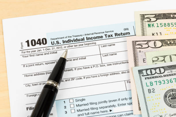 istock Tax form with banknote, and pen 1083320882