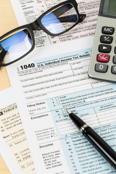 istock Tax form with glasses, calculator, and pen 1083320888