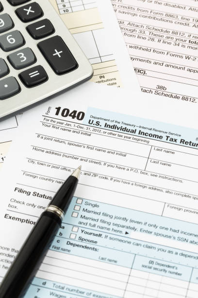 istock Tax form with pen and calculator 1083320912