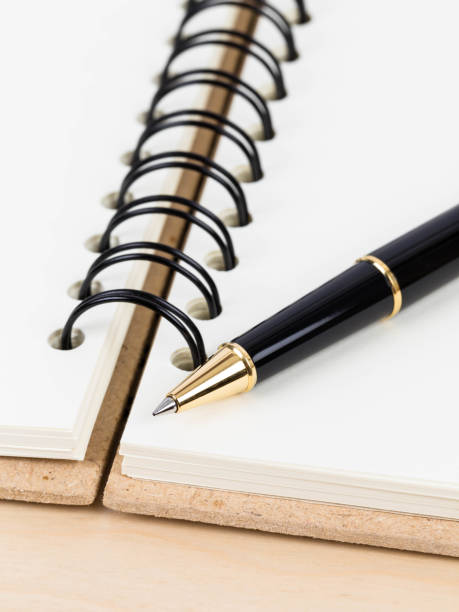 istock Pen on blank page cream color paper notebook 1083320928