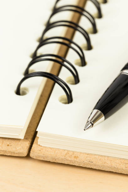 istock Pen on blank page cream color paper notebook 1083320958