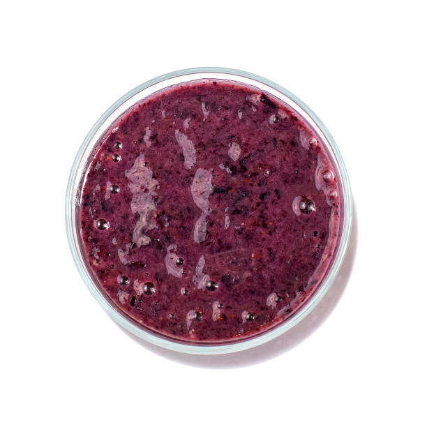 istock Blueberry smoothie in a glass jar isolated on white background. Top view 1083323656