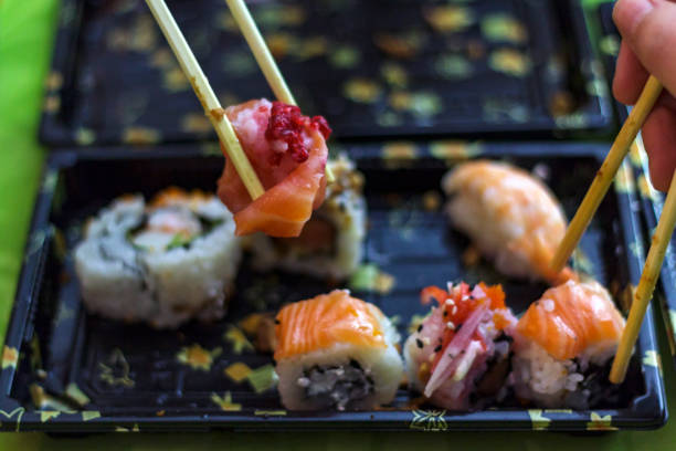 istock Eat sushi with chopsticks at the same time 1083329212