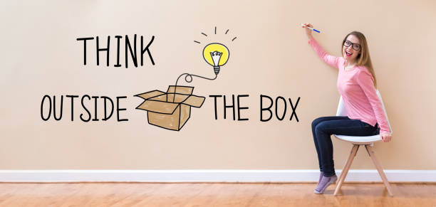 istock Think Outside The Box with young woman holding a pen 1083335004
