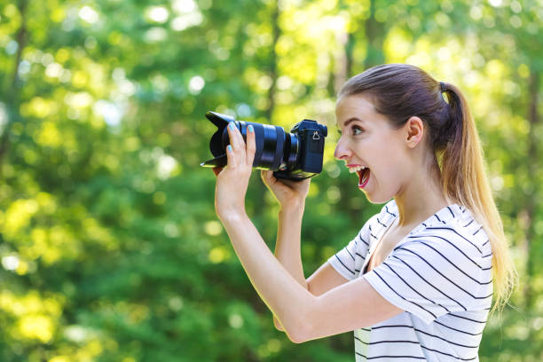 istock Young woman with a professional camera 1083335024