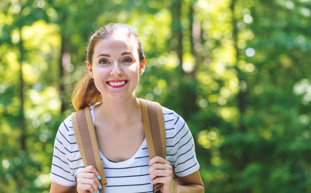 istock Happy young woman hiking 1083335036
