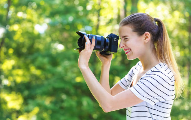 istock Young woman with a professional camera 1083335040