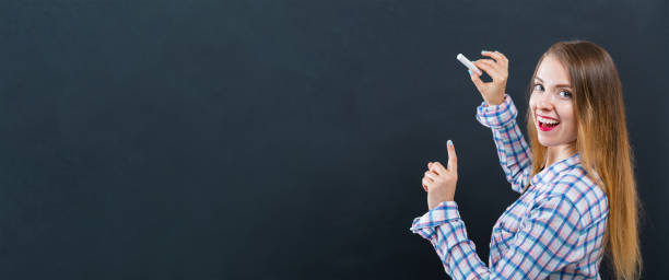 istock Young woman writing on a chalkboard 1083336186