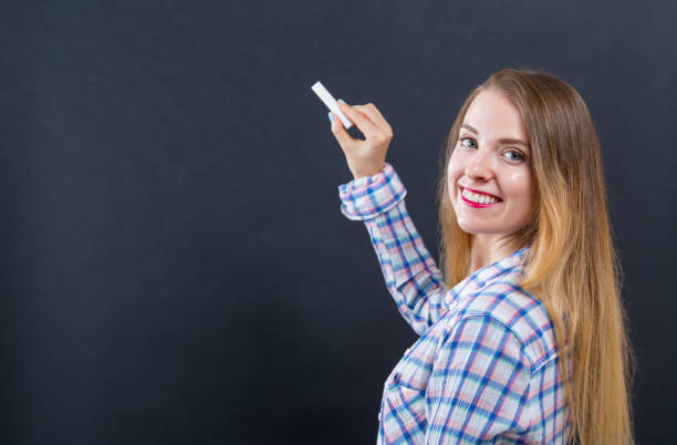istock Woman holding a chalk 1083336236