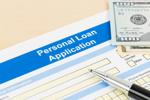 Personal loan application form with dollar money banknote, and pen