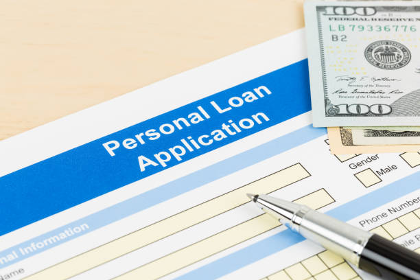 Personal loan application form with dollar money banknote, and pen Personal loan application form with dollar money banknote, and pen personal loan stock pictures, royalty-free photos & images