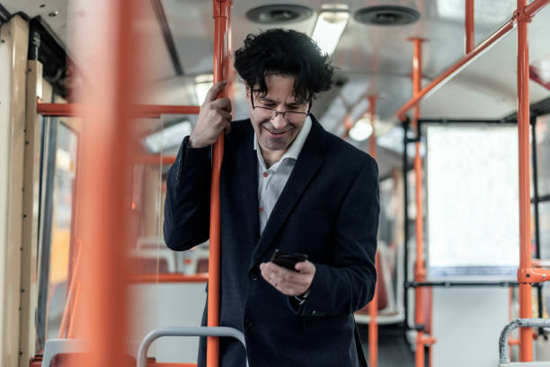 istock Mid Aged Businessman in Public Transport 1083337982