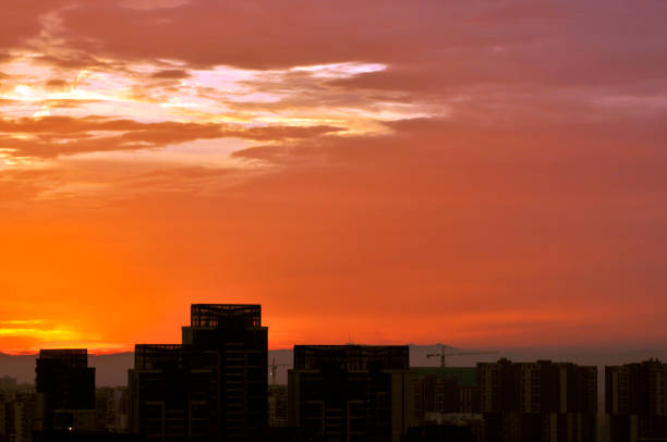 istock Colorful romantic sunset twilight sky in the city background. 1083344294