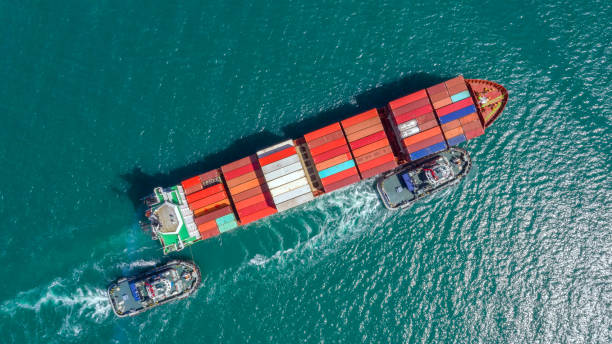 istock Container ship in export and import business logistics and transportation. Cargo and container box shipping to harbor by crane. Water transport International. Aerial view and top view. 1083345862