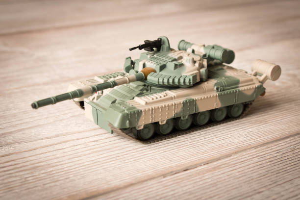 istock Toy model of the Soviet tank on a wooden table. 1083346762