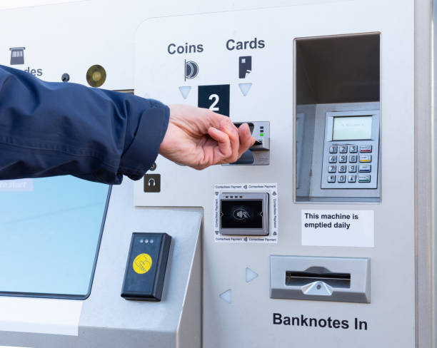 istock Person inserts card to buy ticket at self service machine 1083349356