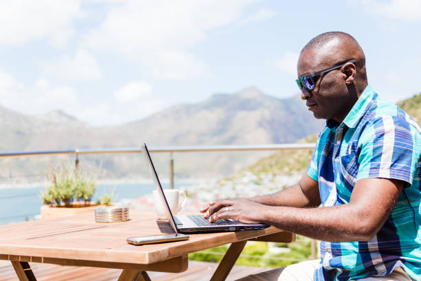 istock African guy writing on his laptop 1083350018