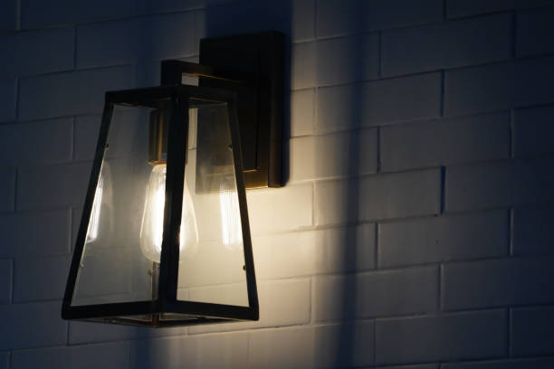 istock Square steel lamp tungsten/warm light on the white brick wall. 1083352078