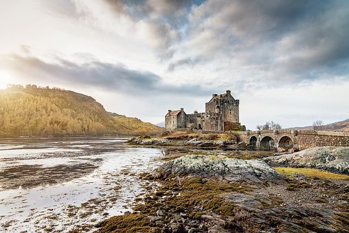Dornie, Scotland, United Kingdom - December 29, 2015: Sunset over the beautiful and famous Eilean Donan Castle on small island in Loch Alsh in the Highland Region of Scotland at Sunset. Dornie, Scotland, United Kingdom