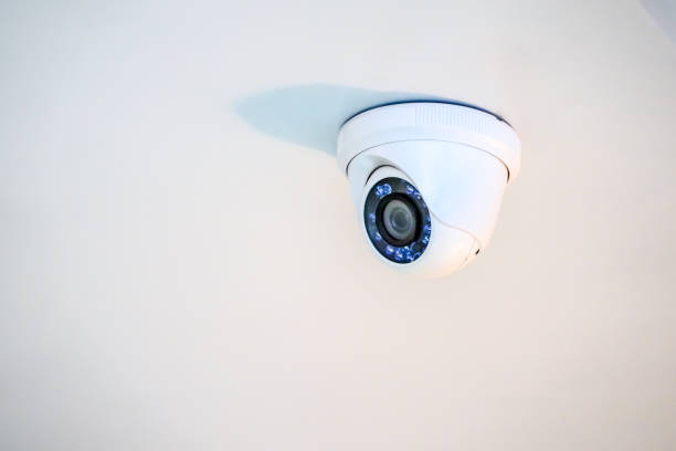 istock white CCTV camera hang on to the ceiling. 1083353780