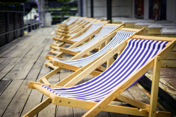 istock Navy line on canvas chairs with old wood terrace. 1083353878