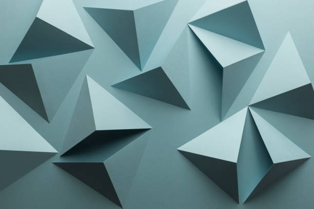 istock Close-up of triangular shapes of paper, abstract background 1083354746