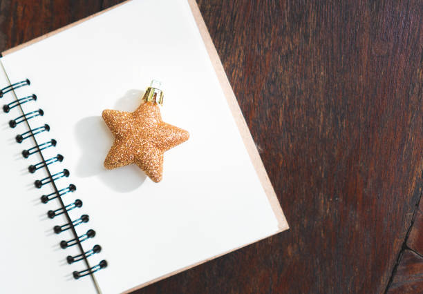 Golden star for decorations on Christmas tree and note book