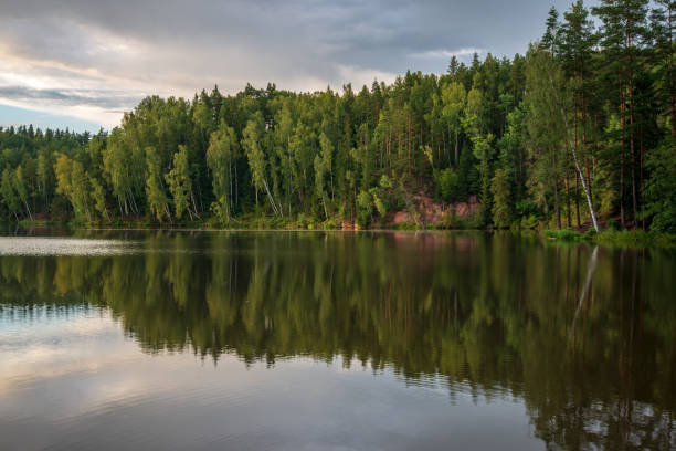 istock blue sky white clouds over calm body of water 1083363268
