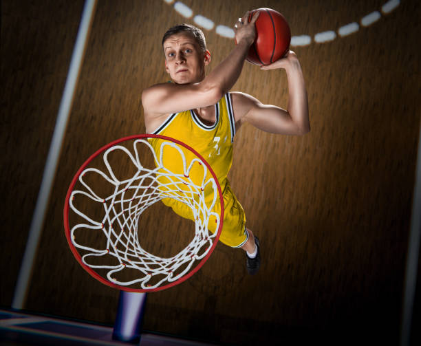 istock basketball player making slam dunk on basketball arena 1083369294