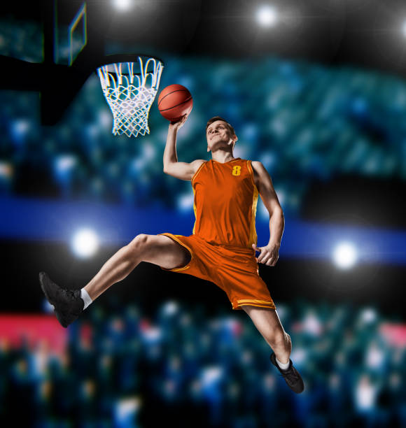 istock basketball player making slam dunk on basketball arena 1083369892