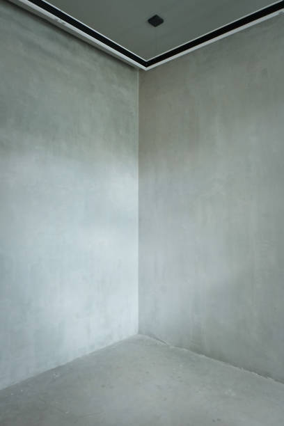 istock Empty concrete room wall and modern lamps 1083373964