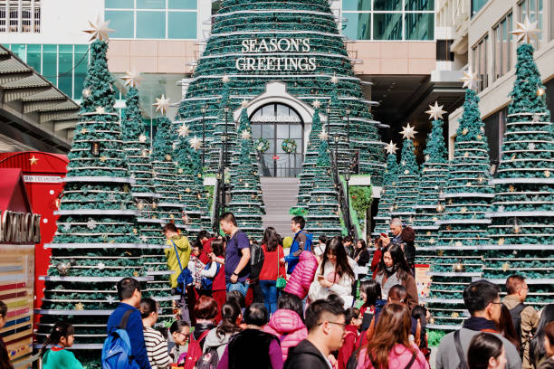 tourists visit harbour city shopping mall. harbour city is hong kong's premier shopping destination. - harbour city imagens e fotografias de stock