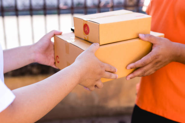 istock Customer receiving the parcel from delivery man. 1083381152