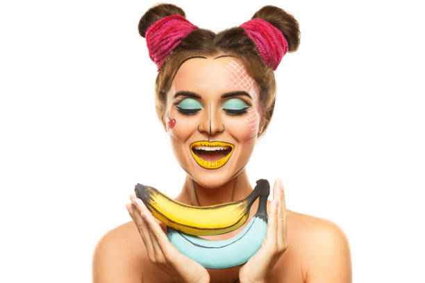 istock Beautiful model with creative pop art makeup holding bananas 1083383424