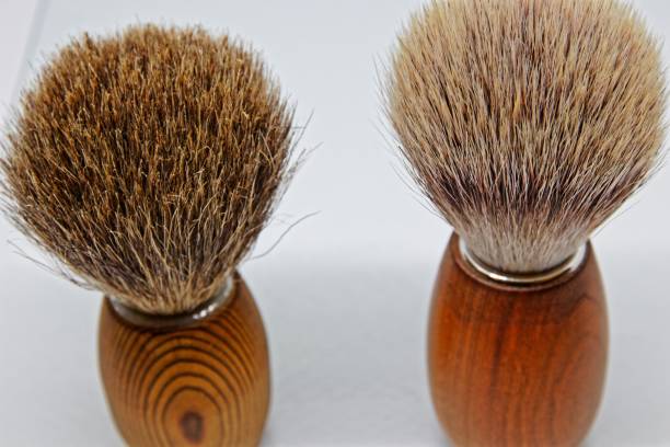 istock Two different shaving brushes, left with badger hair, right vegan artificial bristles 1083385532
