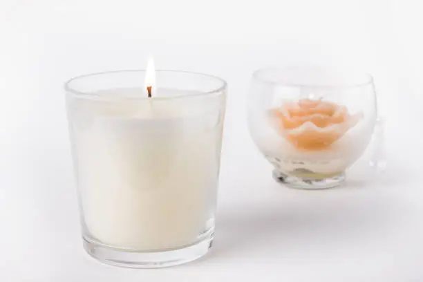 Photo of White Wax Candle in glass on white background