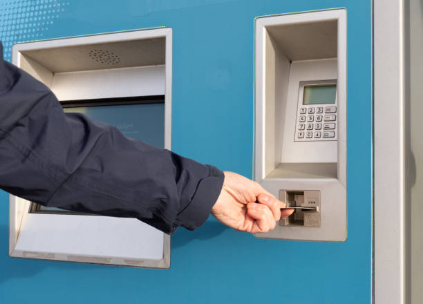 istock Person inserts payment card into a self service ticket machine 1083387746