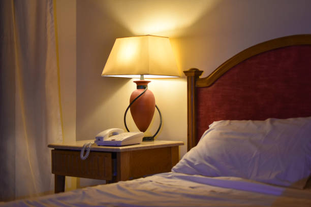 istock Table lamp and telephone in the hotel room 1083388264