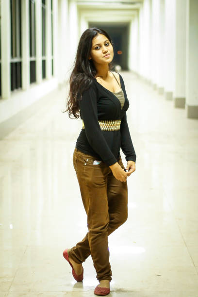 Trendy woman in a long corridor.