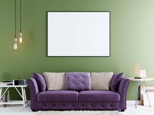 istock Mock up poster on a green wall in modern hipster interior with violet sofa and white table. 1083389944