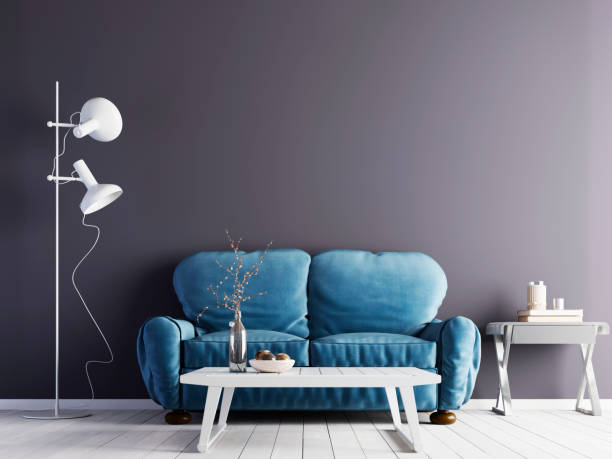 istock Empty violet wall in modern interior with blue sofa and white floor & low table. 1083397020