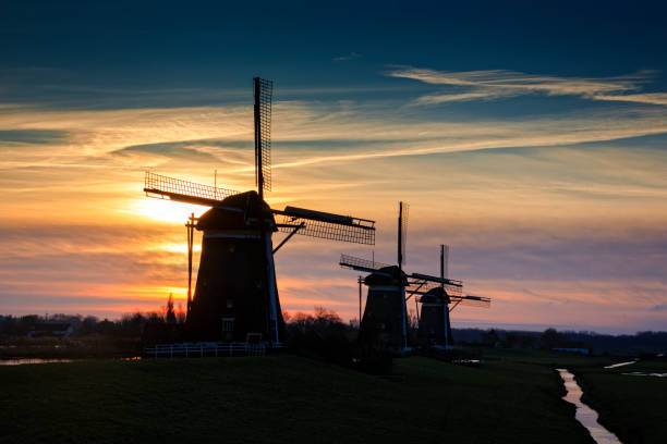 istock typical Dutch windmills in a row just before sunrise 1083401752