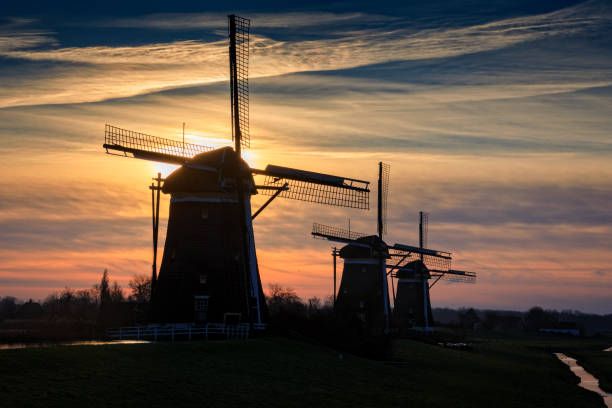 istock typical Dutch windmills in a row just before sunrise 1083404402