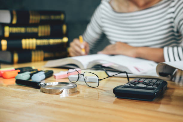 istock Young student sitting at desk in home studying and reading, doing homework and lesson practice preparing exam to entrance, education concept 1083412272