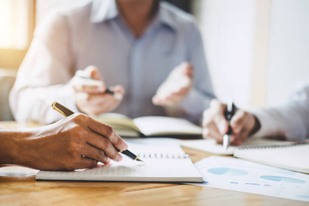 istock Co working conference, Executive team discussing the charts and graphs working in business strategy and financial plan to investment profit 1083412356