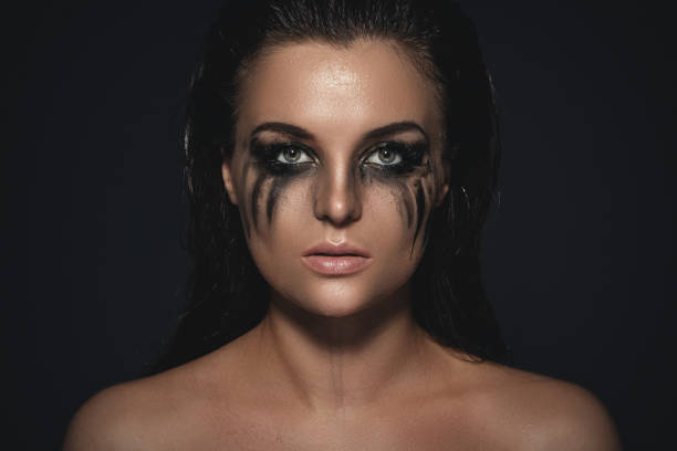 Sad and beautiful woman with smudged makeup on her face Portrait of sad and beautiful woman with smudged makeup on her face woman mascara smudged stock pictures, royalty-free photos & images