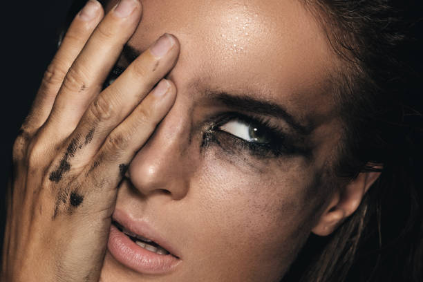 Beautiful woman with smudged makeup on her face Sad and beautiful woman with smudged makeup on her face woman mascara smudged stock pictures, royalty-free photos & images