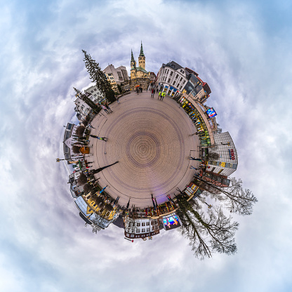 Zilina, Slovakia - January 12, 2016 :  Small planet of the center of the city of Zilina. This place is called square of  Andrej Hlinka where we find homes, shops and Trinity Cathedral. As we see on the picture, the place is Meeting place for locals and discoveries for tourists, this place is a must in the city.  Photo stitching to get a photo of a small planet