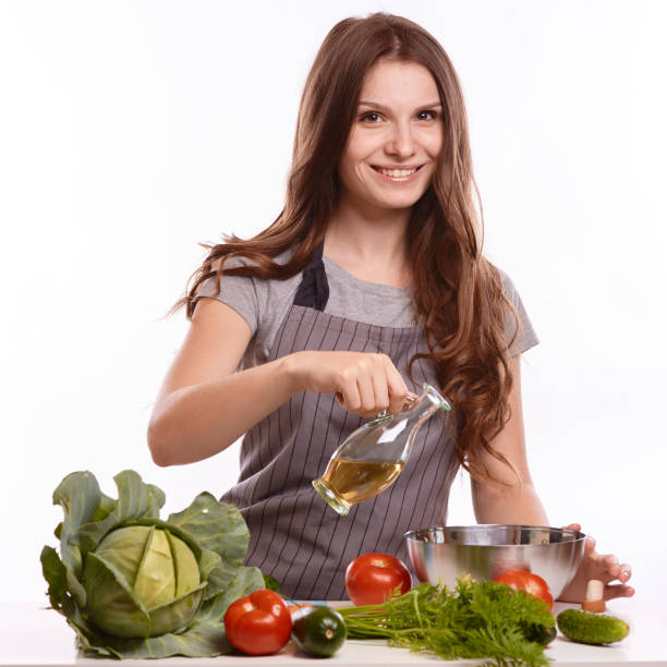 istock happy adult woman with various fresh vegetables on kitchen table looking at camera 1083429046