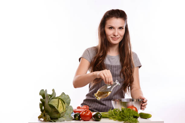 istock happy adult woman with various fresh vegetables on kitchen table looking at camera 1083429058